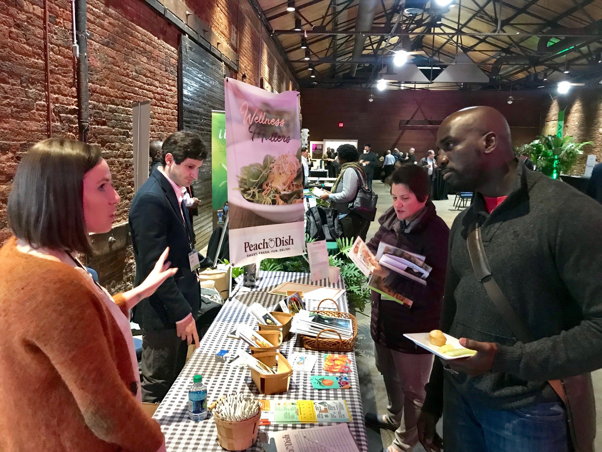 AgLanta attendees talk with local exhibitors (foreground)&nbsp;as other attendees network and enjoy refreshments (background).&nbsp;